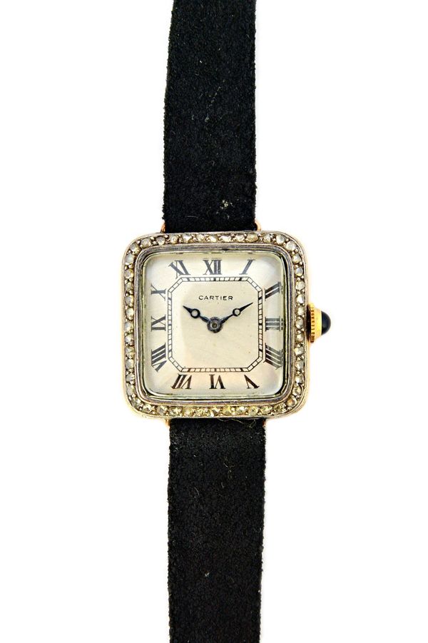 A Cartier yellow and white metal square cased diamond set lady's dress wristwatch, circa 1920, on a black suede strap.  Illustrated