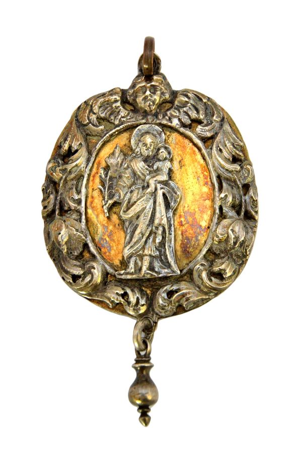 A European parcel gilt devotional pendant, of oval form, with a standing figure and Christ child to the centre, within a foliate scrolling border with