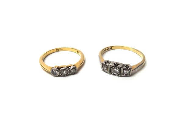 A gold and platinum, diamond set three stone ring, mounted with circular cut diamonds within square shaped settings, detailed 18 CT PLAT, ring size O