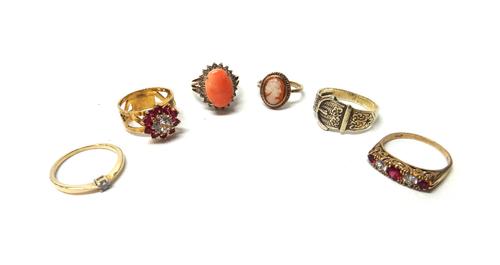 A 9ct gold, red and colourless gem set cluster ring, with pierced decoration, London 1972, a 9ct gold, red and colourless gem set five stone ring, a 9