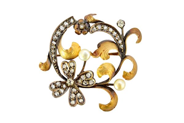 A silver and gold, diamond and cultured pearl set brooch, in a floral and scrolled foliate design, mounted with two cushion shaped diamonds, two cultu