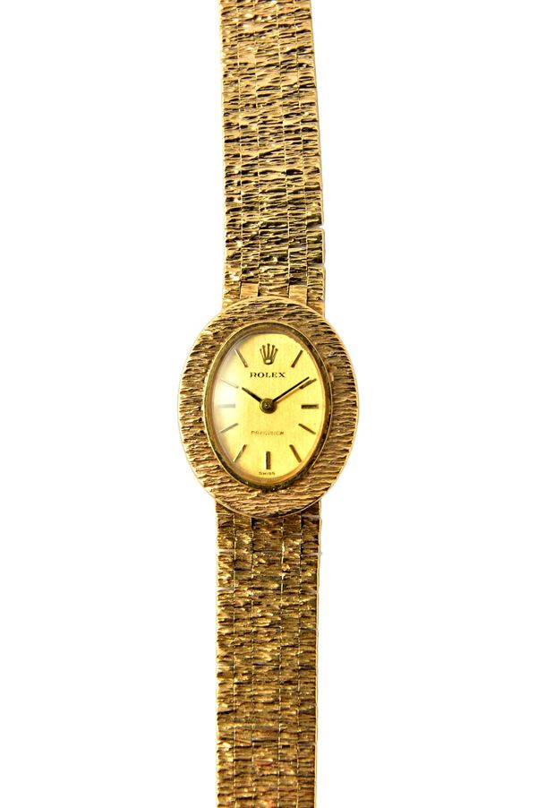 A lady's 9ct gold Rolex bracelet wristwatch, the signed oval gilt dial, with baton shaped numerals and detailed Rolex Precision, the bezel and the bri