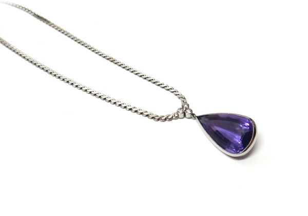 An amethyst and diamond necklace, mounted with a pear shaped amethyst to the drop and with a circular cut diamond set trefoil shaped surmount, on a se