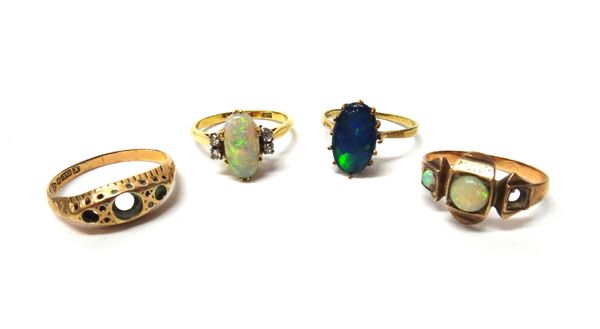 A gold ring, claw set with an oval opal, between diamond set two stone shoulders, detailed 18 CT, a gold ring, mounted with two opals (the third opal