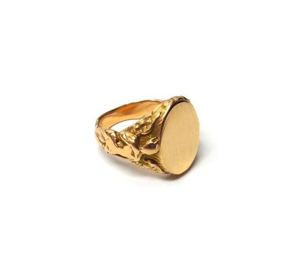 A gold signet ring, each shoulder designed as a classical maiden, supporting the plain oval panel, detailed 14K, ring size Q and a half, gross weight