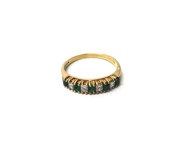 An 18ct gold, emerald and diamond set nine stone half hoop ring, mounted with five square cut emeralds, alternating with four princess cut diamonds, r