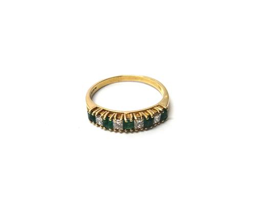 An 18ct gold, emerald and diamond set nine stone half hoop ring, mounted with five square cut emeralds, alternating with four princess cut diamonds, r