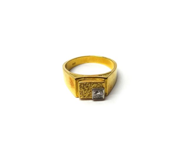 A gold and diamond set single stone ring, in a rectangular abstract panel shaped design, having a textured finish and mounted with a circular cut diam