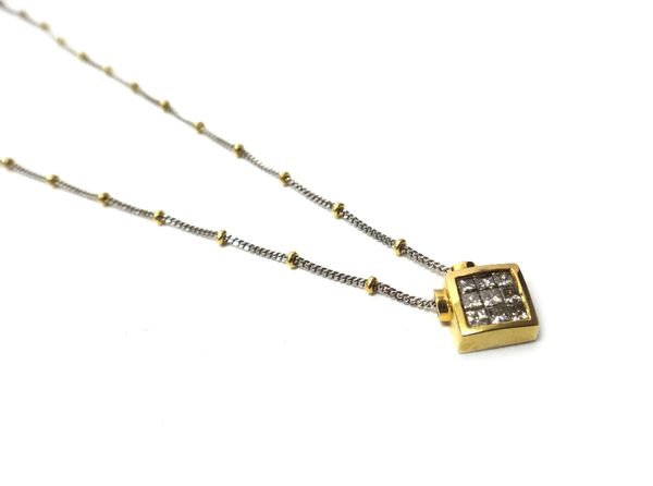 An 18ct two colour gold and diamond set pendant necklace, the lozenge shaped pendant mounted with nine princess cut diamonds, on a faceted curb and be