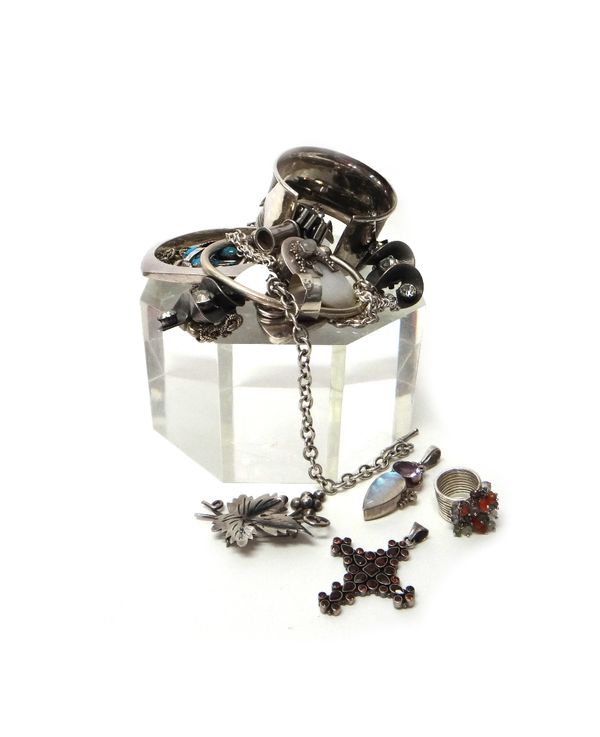 A collection of mostly silver jewellery, comprising; three necklaces and neckchains, three bangles, four mostly gem set pendants, three rings, two bra