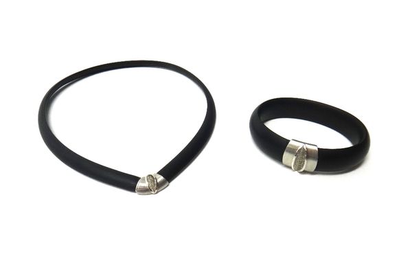 A platinum and diamond mounted black composition bangle and collar necklace, each in a modern design, with a box and a folding case, detailed 'Jewelle