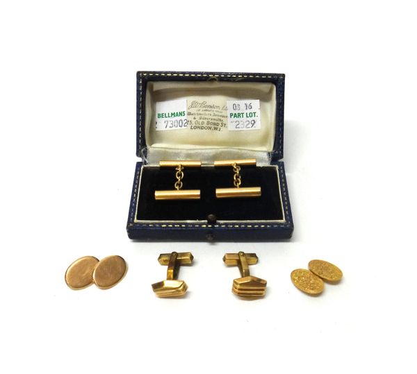 A 9ct gold oval cufflink, with floral and scroll engraved decoration, another gold oval cufflink, connected by a base metal chain, detailed 9, a pair