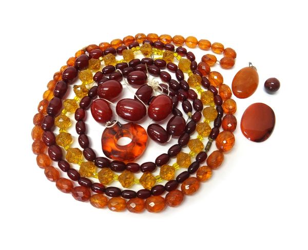 A single row necklace of graduated cultured pearls, the clasp detached, but present, an oval amber pendant, a quantity of faceted cornelian beads, a r