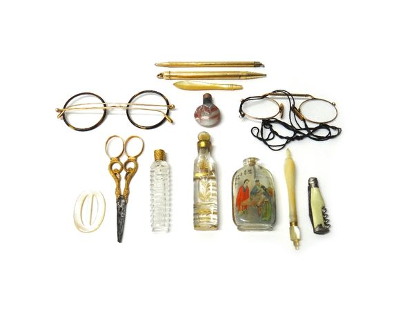 A pair of gold mounted needlework scissors, decorated with serpentine motifs, a gold topped, faceted glass scent bottle, two further scent bottles, tw