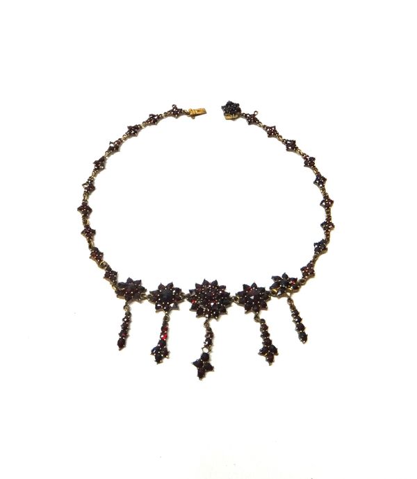 A Bohemian garnet set collar necklace, the front designed as a series of clusters, with five pendant drops, on a snap clasp, (one garnet detached, but