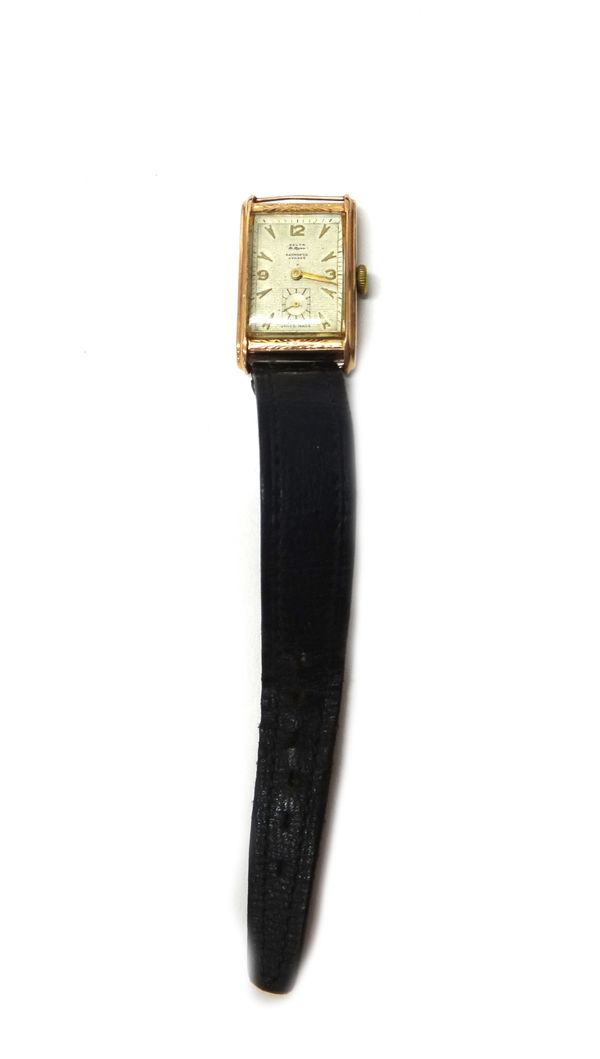 A gentleman's gold rectangular cased wristwatch, the signed dial with gilt Arabic and arrow shaped numerals, subsidiary seconds and with gilt hands, t