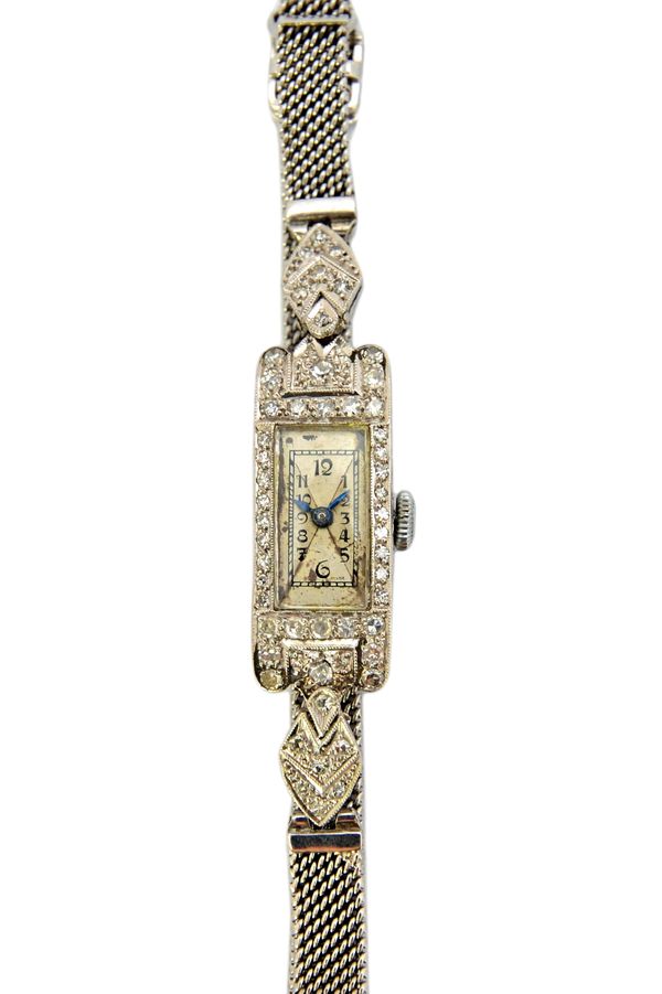 A lady's platinum cased and diamond set rectangular cased dress wristwatch, with a jewelled Swiss movement, the case surround and the bracelet mountin