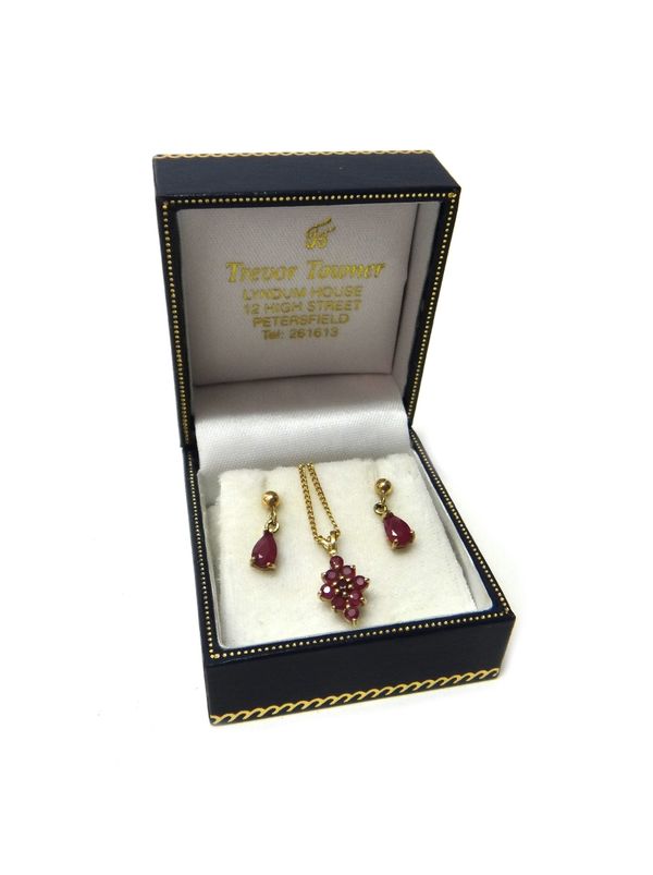 A gold and ruby set nine stone lozenge shaped cluster pendant, detailed 375, with a 9ct gold, curb link neckchain, on a boltring clasp and a pair of g