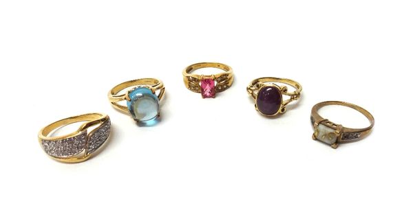 A 9ct gold ring, collet set with an oval cabochon ruby, a 9ct gold ring, mounted with a native gold in quartz centre stone and three further 9ct gold