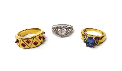 An 18ct white gold and diamond set ring, in a heart shaped design, mounted with circular cut and baguette diamonds, an 18ct gold ring, claw set with a