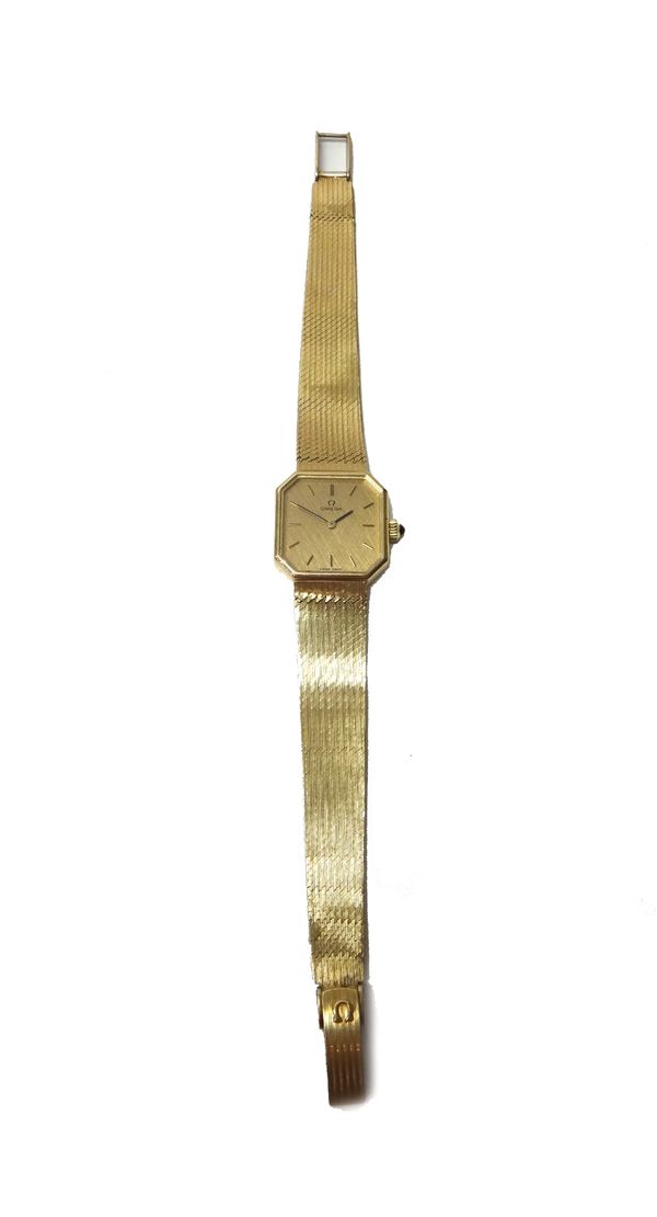 A lady's 9ct gold Omega dress wristwatch, the cut cornered square gilt dial with baton shaped numerals, on a tapering woven mesh link gold bracelet, w