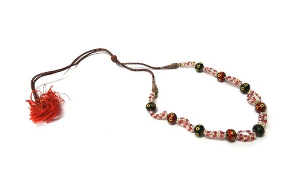 An Indian seed pearl, ruby bead and enamelled necklace, probably Indian, in a four row seed pearl and ruby bead design, spaced with alternating gem se