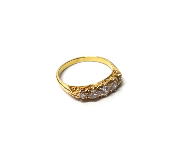 A gold and diamond set five stone ring, claw set with a row of cushion shaped diamonds graduating in size to the centre stone, the mount decorated wit