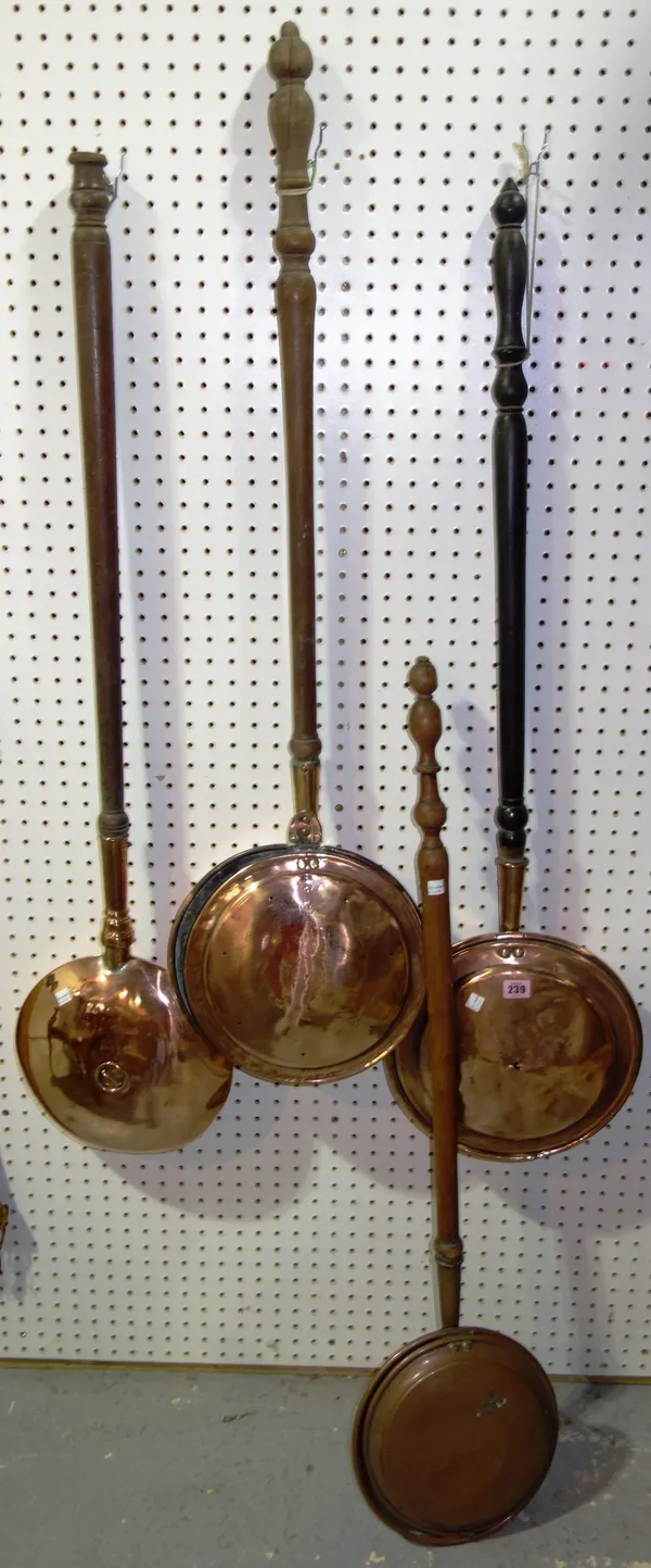 A group of four copper warming pans. (4)