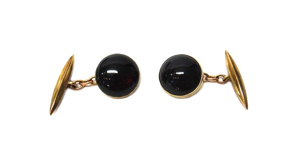 A pair of 9ct gold cufflinks, set with circular cabochon garnets to the fronts and with fluted torpedo shaped backs, Birmingham 1967, with makers mark