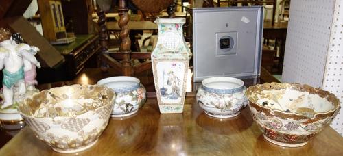 A pair of Japanese bowls decorated with fish and flowers, a pair of large Satsuma bowls and a famille rose vase with painted panels. (5)