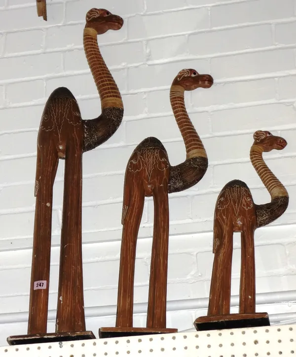 A group of three carved wooden models of camels. (3)