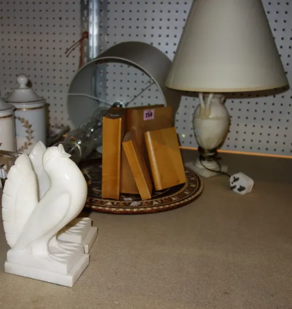 A 20th century glass table lamp, a pair of wooden bookends formed as books, an inlaid Egyptian style plate, two marble bookends in the form of doves a