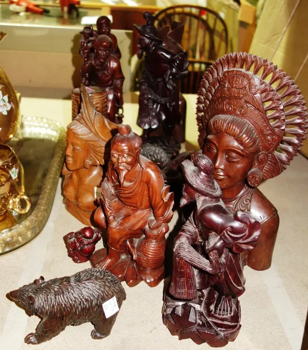A quantity of 20th century carved hardwood heads and figures, (qty).