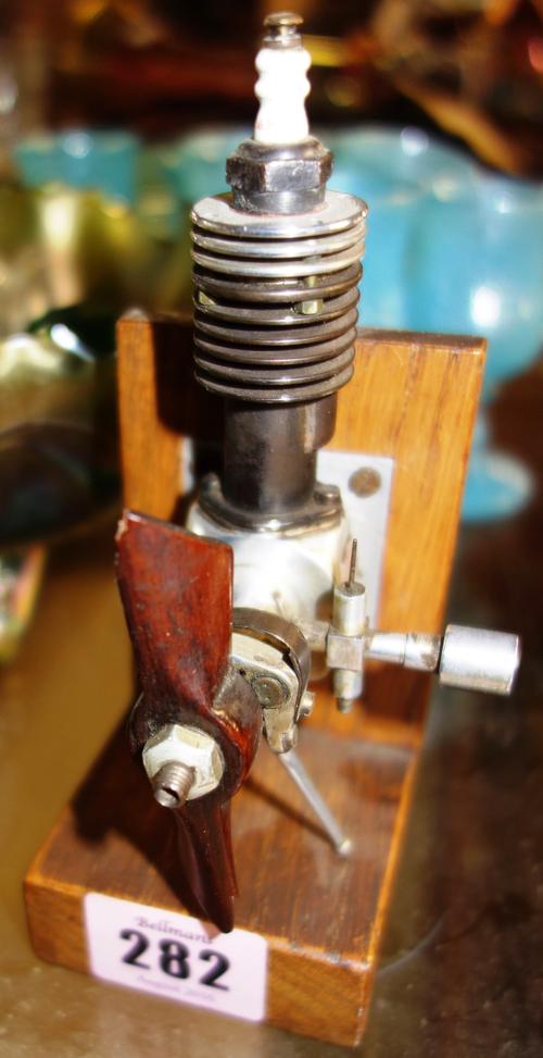 An early 20th century model airplane engine on stand.