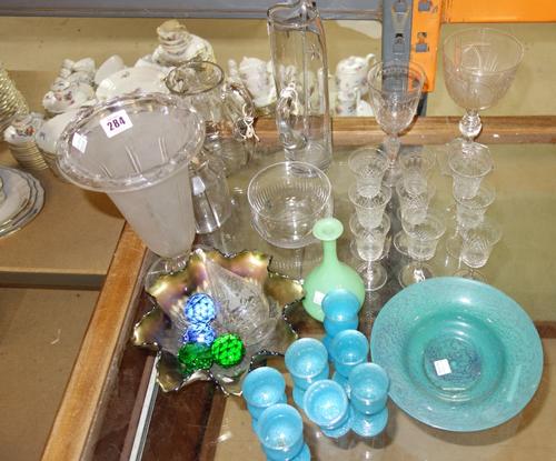 A quantity of assorted glassware including etched drinking glasses, decorative bowls and a large quantity of decanter stoppers.