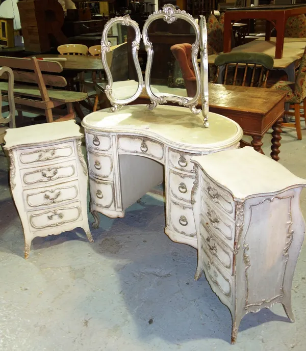 A Louis XV style suite of furniture including dressing table, triptych mirror and a pair of commodes, (4).
