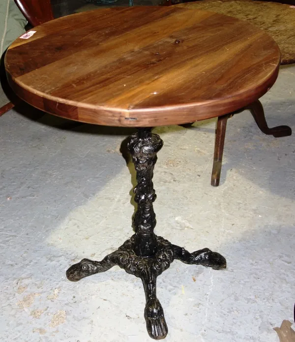 A hardwood top table on cast iron foliate base and shaped feet, 62cm.