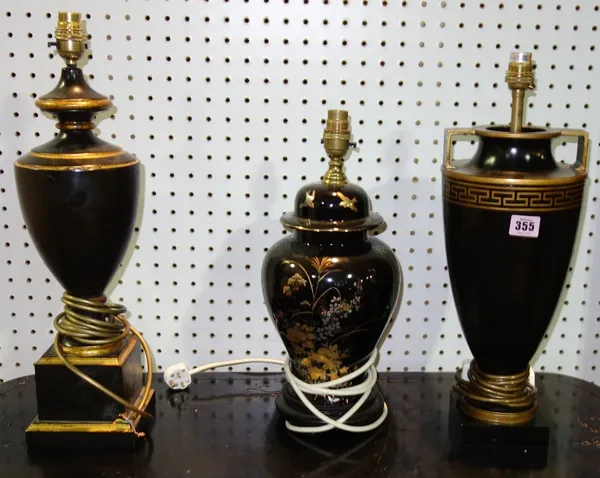A group of three black and gilt decorated table lamps.