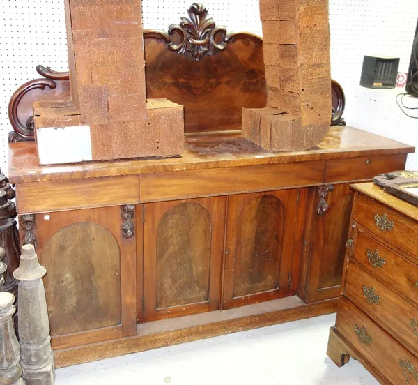 A 19th century mahogany sideboard, the carved back over three flush fit frieze drawers and four panel cupboards, on plinth base, 183cm wide.