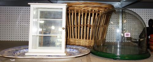 A large blue and white decorated serving plate, a large glass dome, a small white painted wall cabinet and a basket. (4)