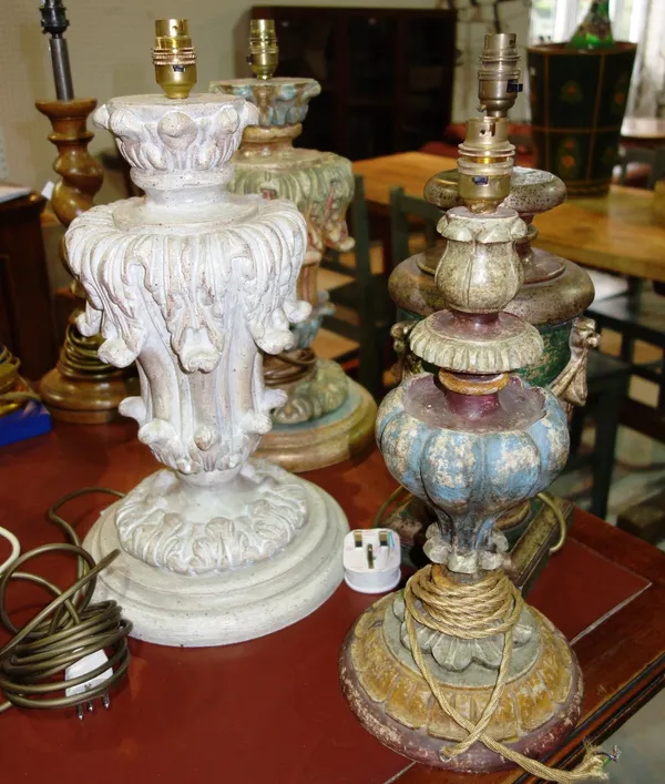 A group of four carved wood and painted table lamps.
