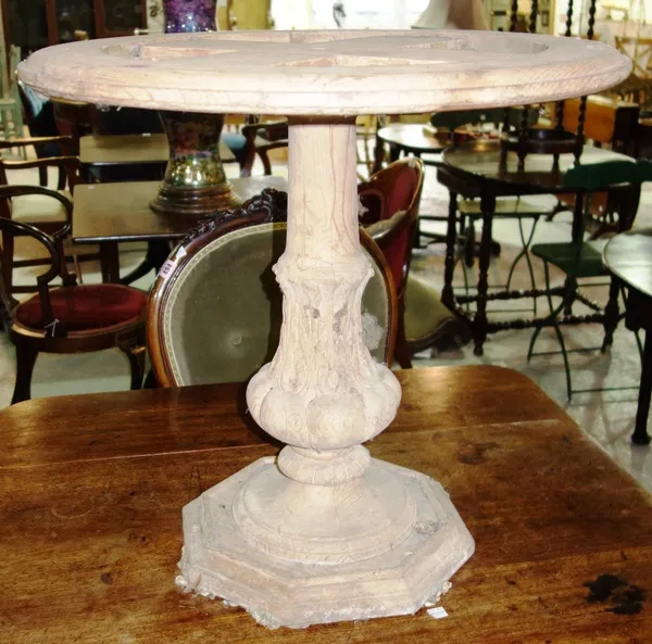 A circular carved pine table base.