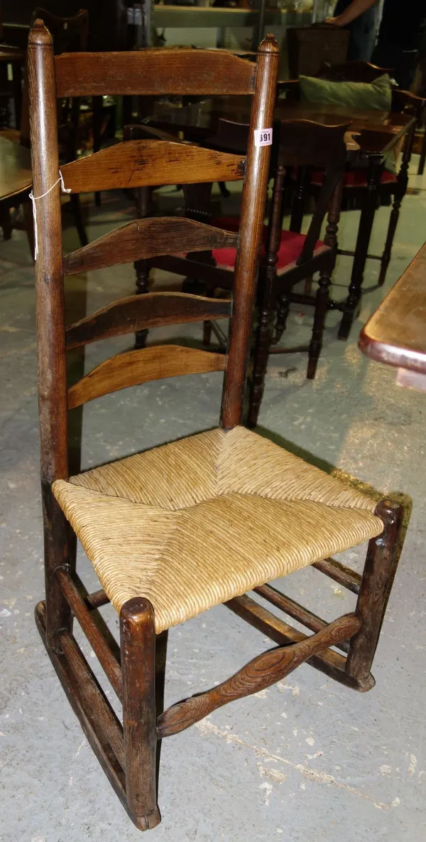 A 19th century ash ladder back rocking chair.