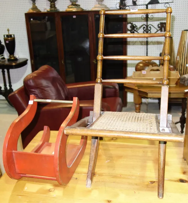 A folding walnut chair with caned seat and a 20th century Canterbury formed as a sleigh.
