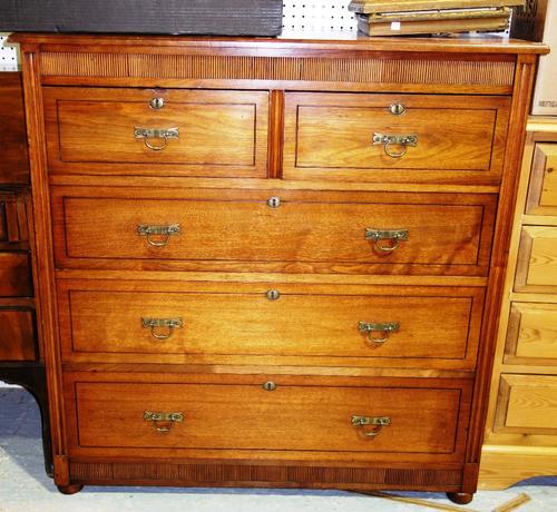 A late 19th century teak chest of two short and three long graduated drawers, on compressed bun feet, 107cm wide.