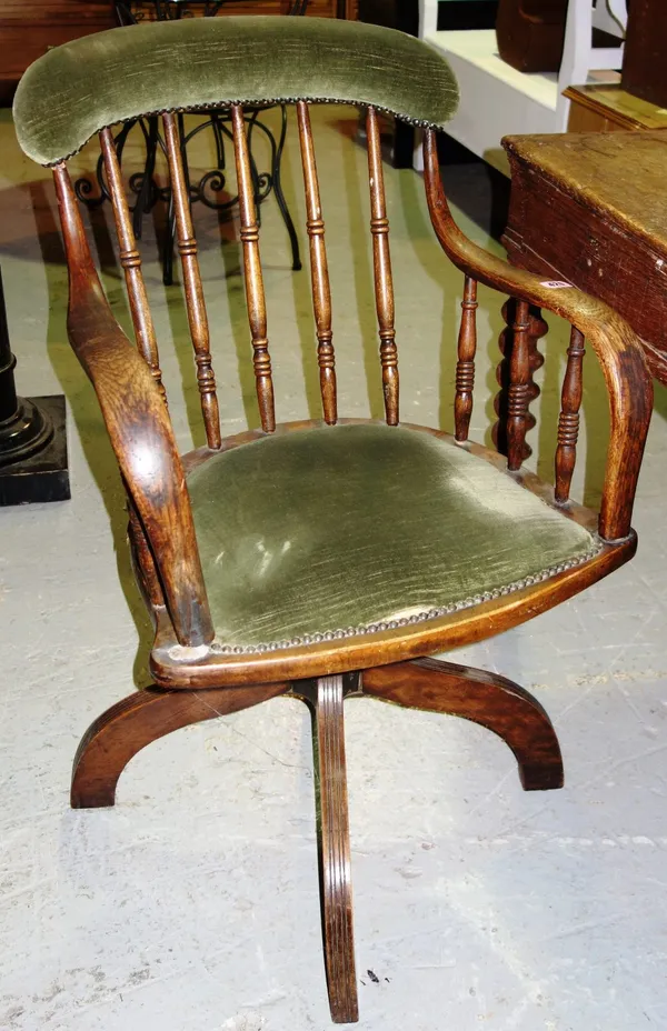 An Edwardian oak office swivel chair.