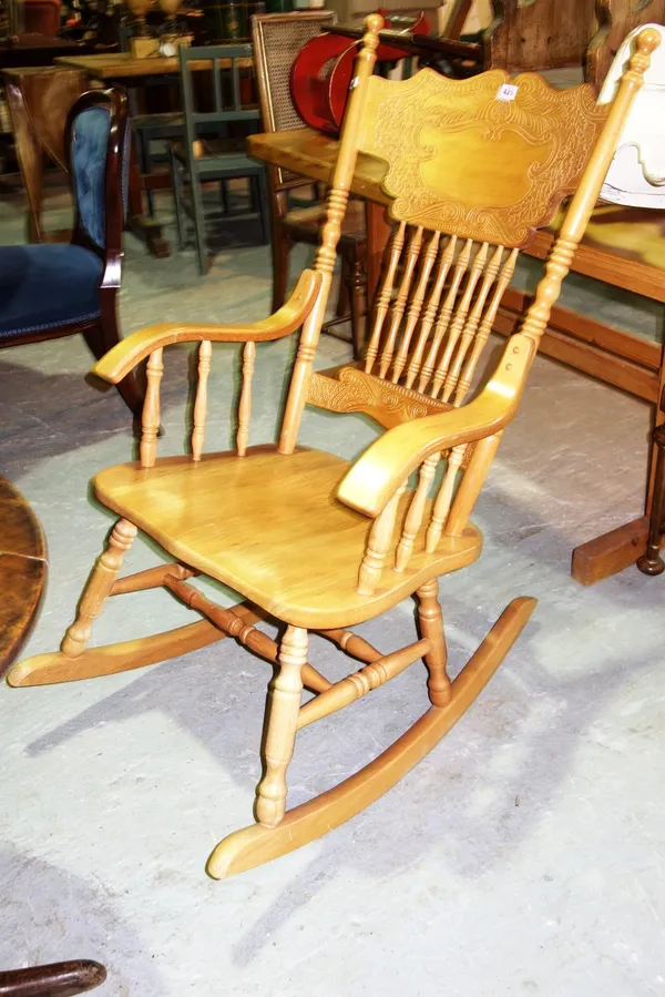 A 20th century beech stick back rocking chair.