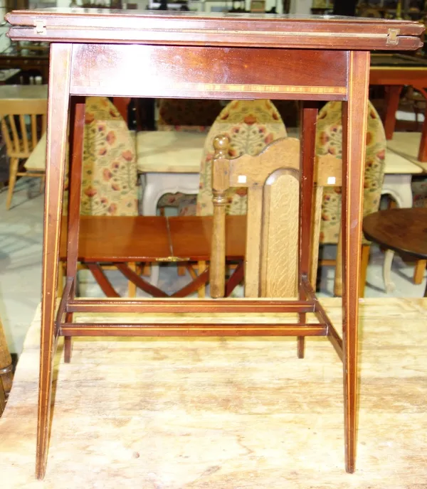 An Edwardian mahogany foldover table.