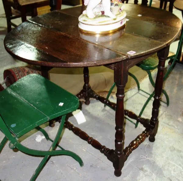 An 18th century oak drop flap table and a 20th century oak stick stand. (2)