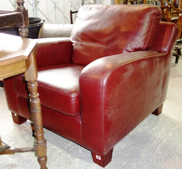 A pair of 20th century red leather upholstered easy armchairs. (2)